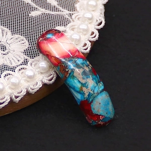 Macro detail of curved natural stone connector with red and blue marbled texture