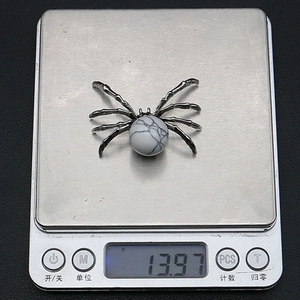 Detailed view of an antique silver spider pendant with marble stone weighing 13.97g