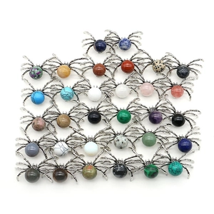 Spider shaped natural stone pendants in various colors like lapis and rose quartz