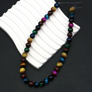 Macro view of multi-color tiger eye round beads with silk luster for DIY jewelry making