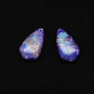 Macro view of purple synthetic turquoise shield pendants with natural vein texture
