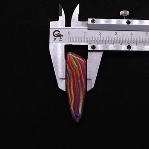 Width measurement of striped natural stone knife pendant showing 1.5cm on a caliper tool