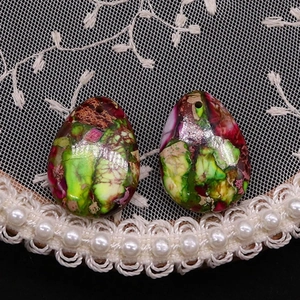 Detailed view of teardrop synthetic turquoise pendants with vibrant marbled texture