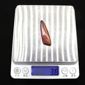 Rainbow striped imperial stone irregular pendant on scale showing 3.8g weight