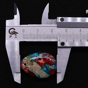 Macro shot of a 35mm teardrop imperial jasper stone pendant with vivid textures