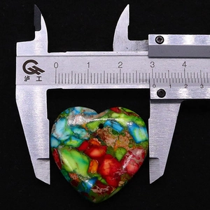 Dettaglio del ciondolo a cuore in mosaico di 28 mm misurato con un calibro digitale