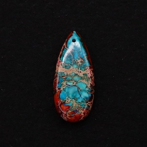 Macro shot of teardrop shaped red and blue emperor stone pendant with pre-drilled hole