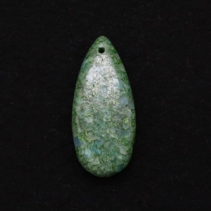 Macro detail of teardrop emperor stone pendant with natural mineral mosaic texture