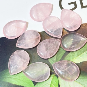 Macro view of polished teardrop rose quartz gemstones with natural internal textures