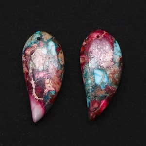 Macro shot of two multi-color crescent stones with artistic marble patterns for DIY jewelry