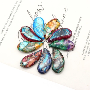 Set of nine colorful crescent Imperial Stone pendants with natural mineral textures for DIY