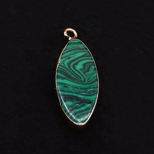 Macro view of marquise-shaped malachite pendant with electroplated gold edge and ring