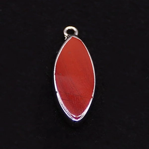 Macro shot of marquise red opal stone pendant with elegant silver plated metal edge