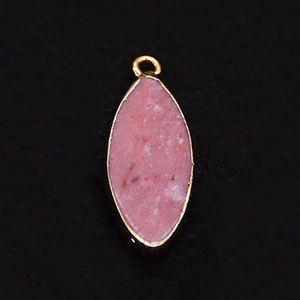 Macro view of pink opal marquise pendant with gold-plated edges and a top loop