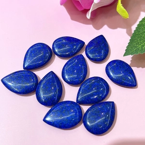 Detailed macro view of polished teardrop lapis lazuli stones for DIY jewelry making