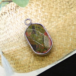 Macro view of oval natural picture jasper pendant with silver plated metal border