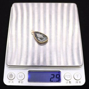 Detail showing natural gemstone pendant weight of 2.9g on a digital scale