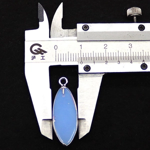 Macro view of blue opal stone pendant measuring 12mm width with digital calipers