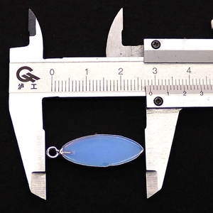 Measurement of light blue marquise stone pendant with silver frame using a caliper