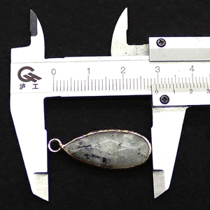 Measurement of teardrop stone pendant with gold edge using a digital caliper