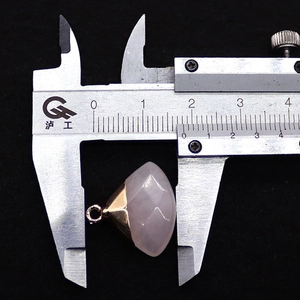 Makroaufnahme eines 1,8 cm facettierten Rosenquarz-Anhängers mit Goldkappe auf schwarzem Grund