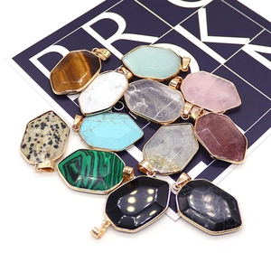 Shield-shaped natural stone pendants with gold-plated edges in various gemstones