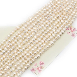 Natural white freshwater pearls for DIY jewelry making displayed on a floral card