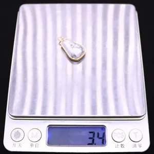 Detailed close-up showing a natural trapezoid pendant on a digital scale weighing 3.4 grams