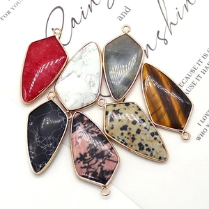 Set of shield-shaped natural stone pendants with gold plated edges and various stone textures