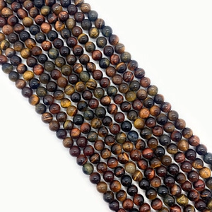 Macro shot of polished round natural Phoenix stone beads with smooth surface for DIY jewelry
