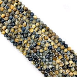 Macro detail of mixed tiger eye stone beads with golden and blue stripes for DIY jewelry