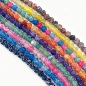 Macro shot of colorful dragon vein agate round beads with detailed crackle textures