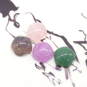 Polished natural stones like rose quartz and green aventurine in flower-shaped designs
