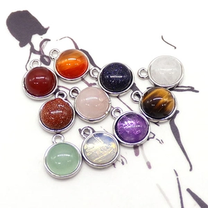 Natural round gemstone pendants in silver metal settings with tigers eye and gold sand stone