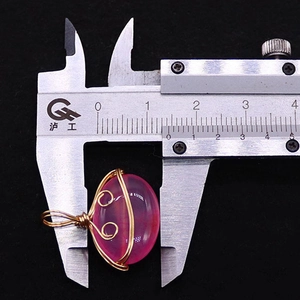 Detailed measurement of pink oval striped agate pendant with gold wire wrapping