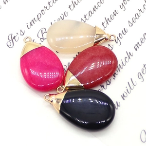 Polished teardrop natural stone pendants in white, pink, red, and black with gold caps