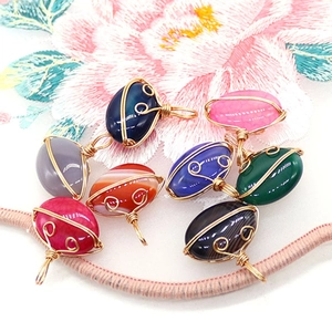 Set of eight handmade wire-wrapped striped agate oval pendants with golden spiral design