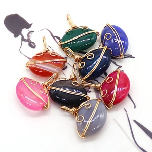 Oval striped agate wire-wrapped pendants in multiple colors with gold metal winding