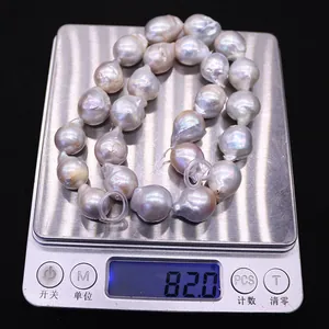 Detailed view of large baroque lavender pearls on a digital scale weighing 82.0g