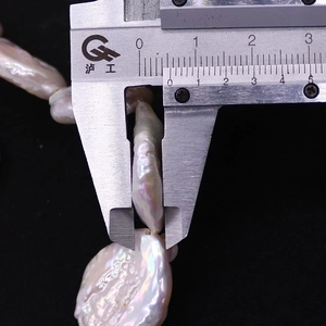 Macro shot of a 9mm irregular baroque pearl thickness measurement using a digital caliper