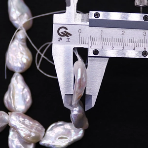 Macro detail of natural freshwater baroque pearl with iridescent luster and waterdrop shape