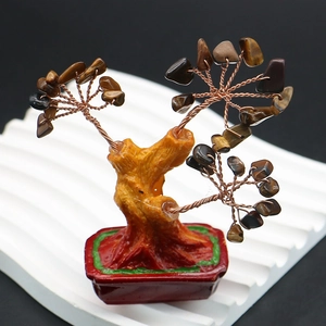 Detailed view of handmade tiger eye crystal money tree with copper wire and resin base