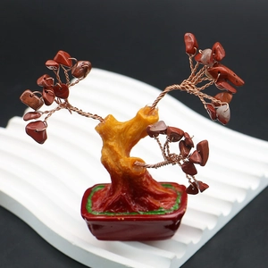 Macro detail of red gemstone money tree with copper wire branches and resin wood base