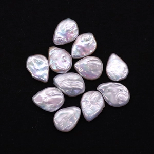 Lustrous iridescent pink baroque teardrop pearls set of 11 pieces on black background