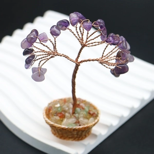 Macro shot of amethyst crystal life tree with copper wire branches on a woven base