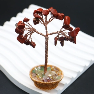 Detailed view of handmade crystal money tree with red gemstones and copper wire trunk