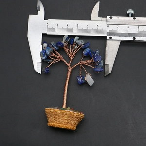 Macro shot measuring the blue gemstone crystal money tree with a digital caliper tool