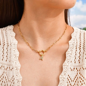 Gold 18K plated paperclip chain necklace with a rhinestone letter A pendant on a model