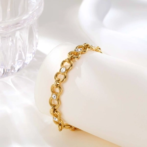 Close-up of gold stainless steel link chain bracelet with clear zircon infinity detail
