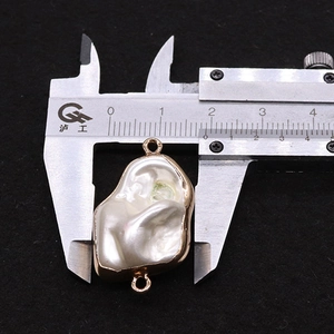 Detailed macro view showing the 18mm baroque pearl pendant size on a digital caliper tool